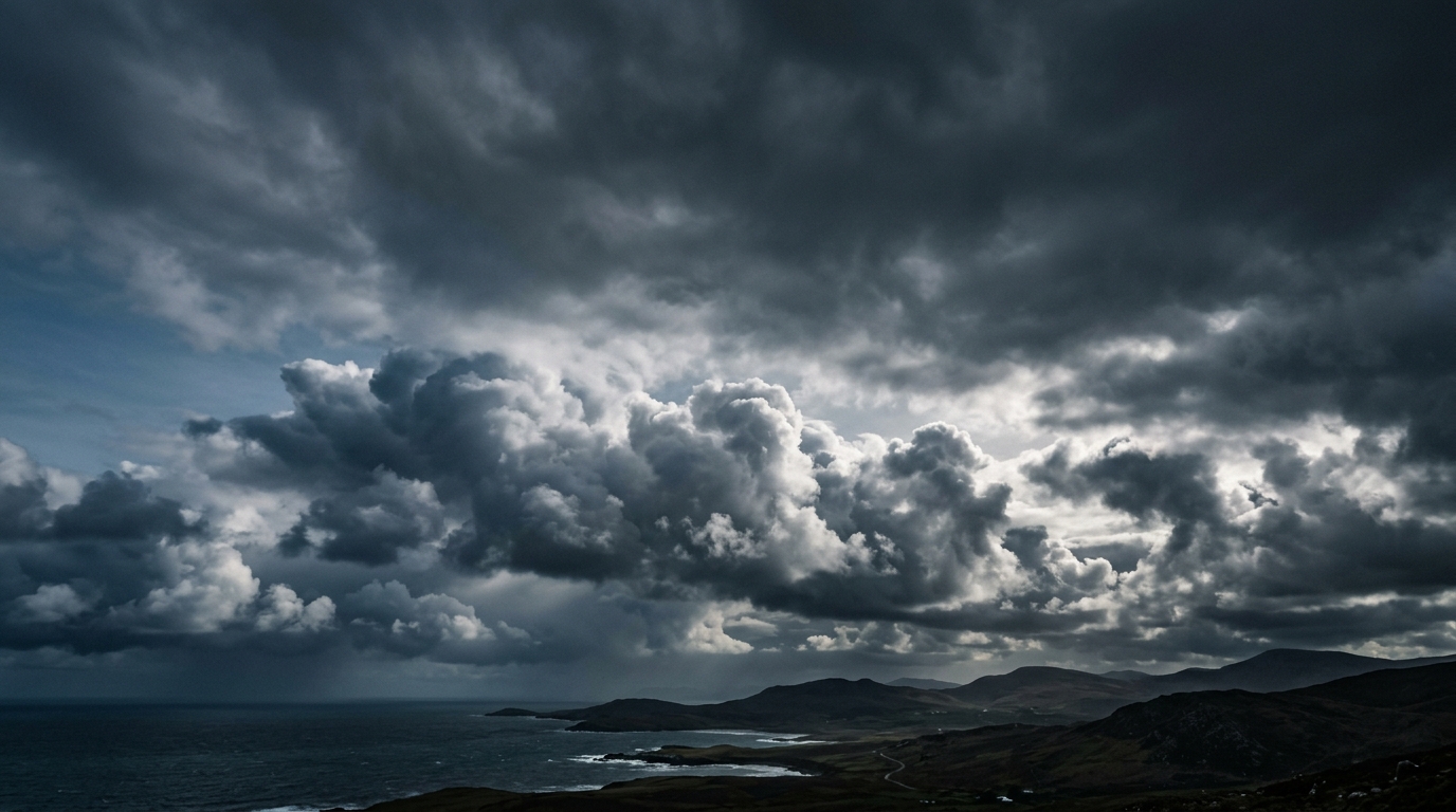 Photorealistic photo of fluffy white clouds, wide shot with open space at the top for text, moody dark tones, dramatic lighting, 16:9 aspect ratio