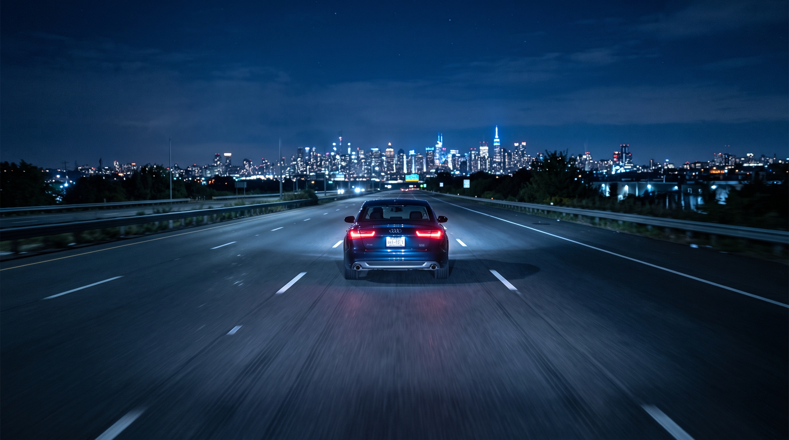 Photorealistic photo of car driving on an empty highway at night with city lights, centered subject with a simple uncluttered composition, cool blue tones, quiet atmosphere, 16:9 aspect ratio
