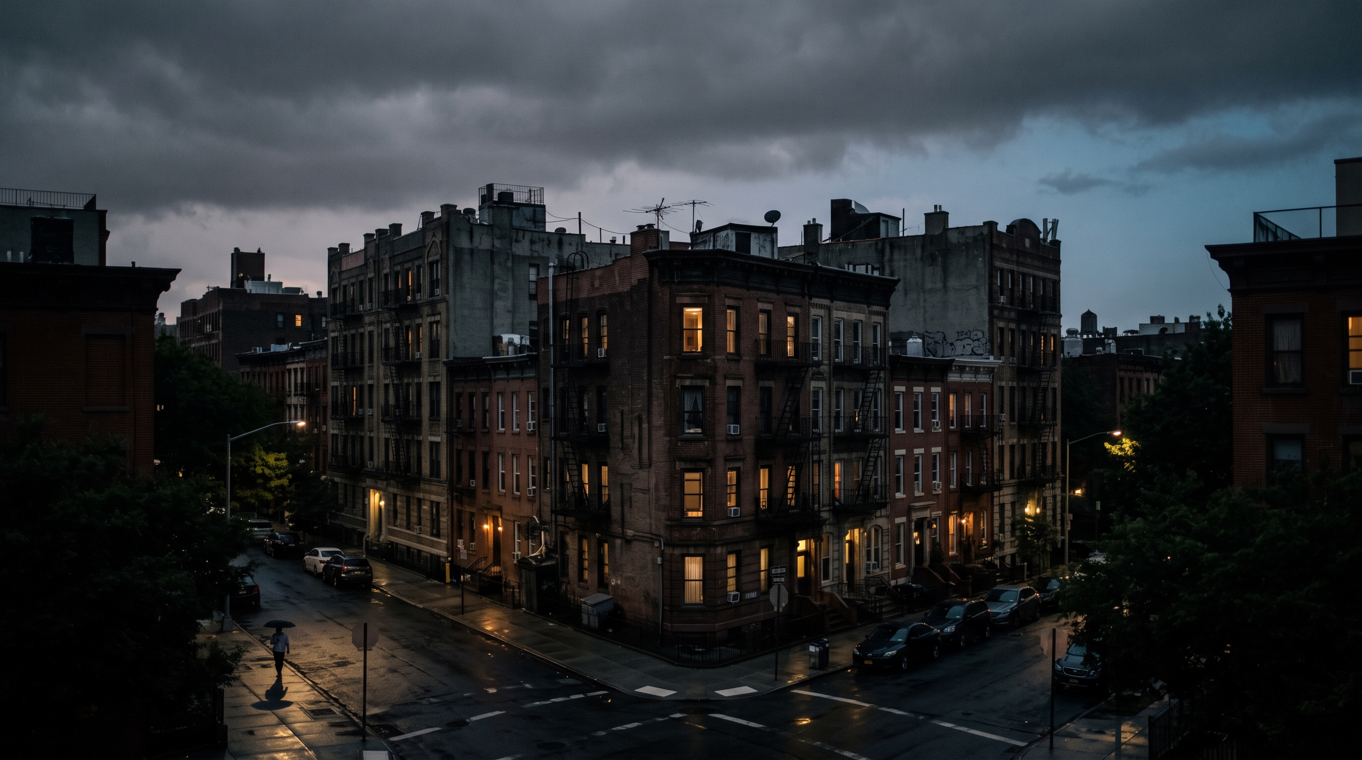 Cinematic film still of city apartment buildings and houses, centered subject with a simple uncluttered composition, moody dark tones, dramatic lighting, 16:9 aspect ratio