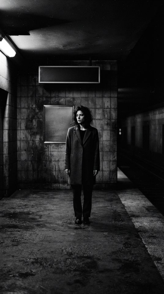 Cinematic film still of black and white minimalist scene with strong shadows, centered subject with a simple uncluttered composition, moody dark tones, dramatic lighting, 9:16 aspect ratio