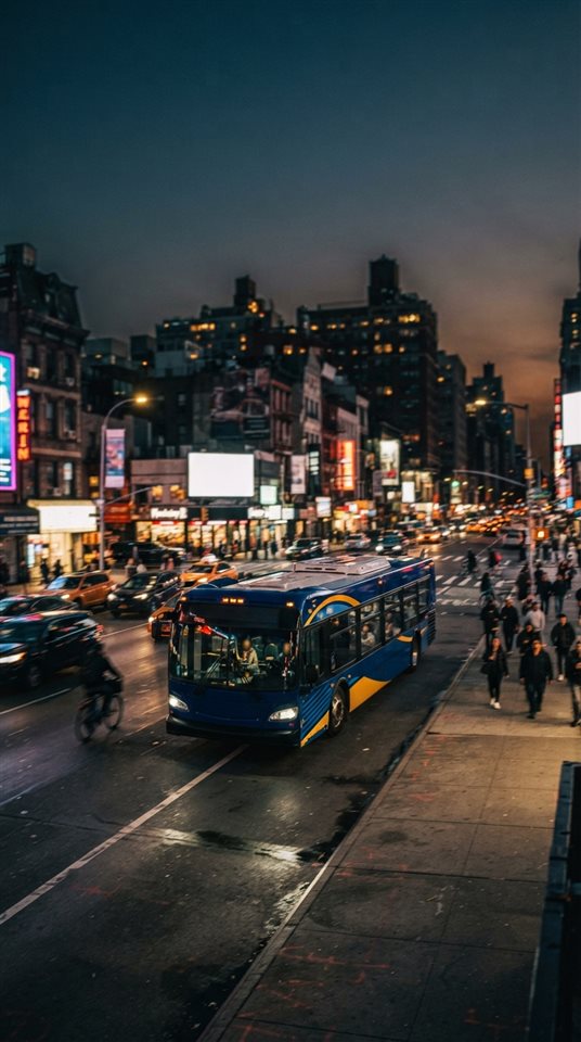 Cinematic film still of a city bus on a street, wide shot with open space at the top for text, vivid colors, high contrast, energetic, 9:16 aspect ratio