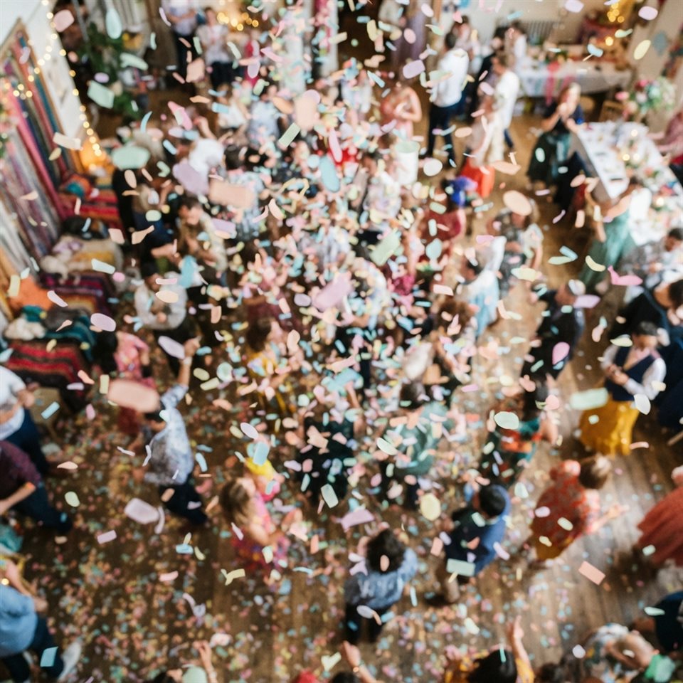 Photorealistic photo of colorful confetti falling, high-angle view from above, soft pastel colors, bright and cozy, 1:1 aspect ratio