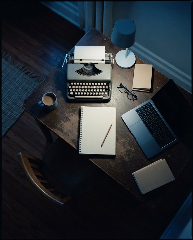 Cinematic film still of workspace desk, high-angle view from above, cool blue tones, quiet atmosphere, 4:5 aspect ratio