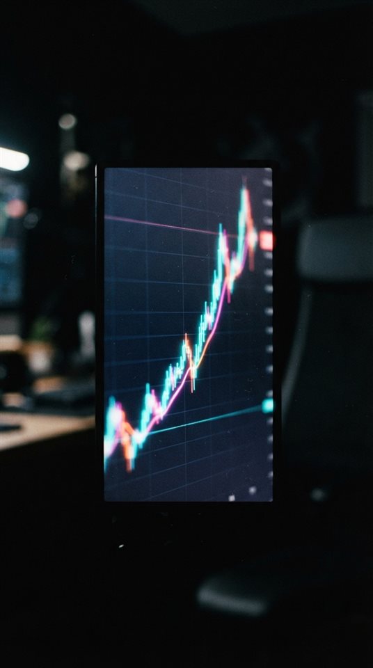 Cinematic film still of A glowing line graph showing upward financial trends on a dark screen, close-up detail with shallow depth of field, vivid colors, high contrast, energetic, 9:16 aspect ratio