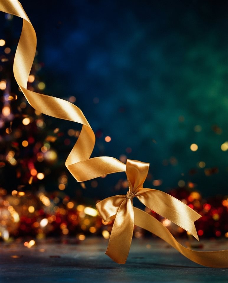 Cinematic film still of A shiny golden ribbon on a clean background, elegant and celebratory design element, wide shot with open space at the top for text, vivid colors, high contrast, energetic, 4:5 aspect ratio