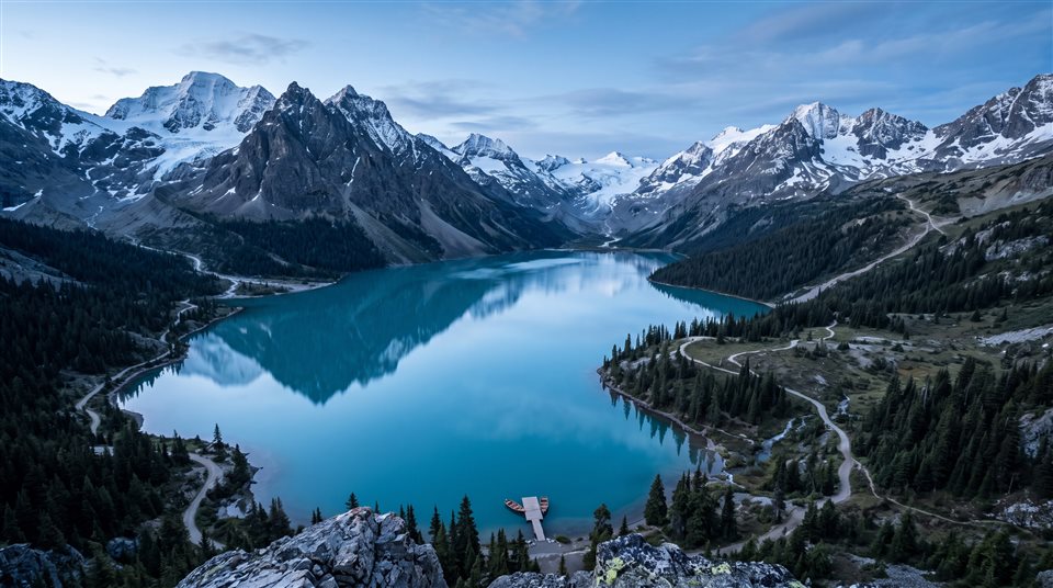 Photorealistic photo of ultra detailed majestic mountain lake landscape, high-angle view from above, cool blue tones, quiet atmosphere, 16:9 aspect ratio