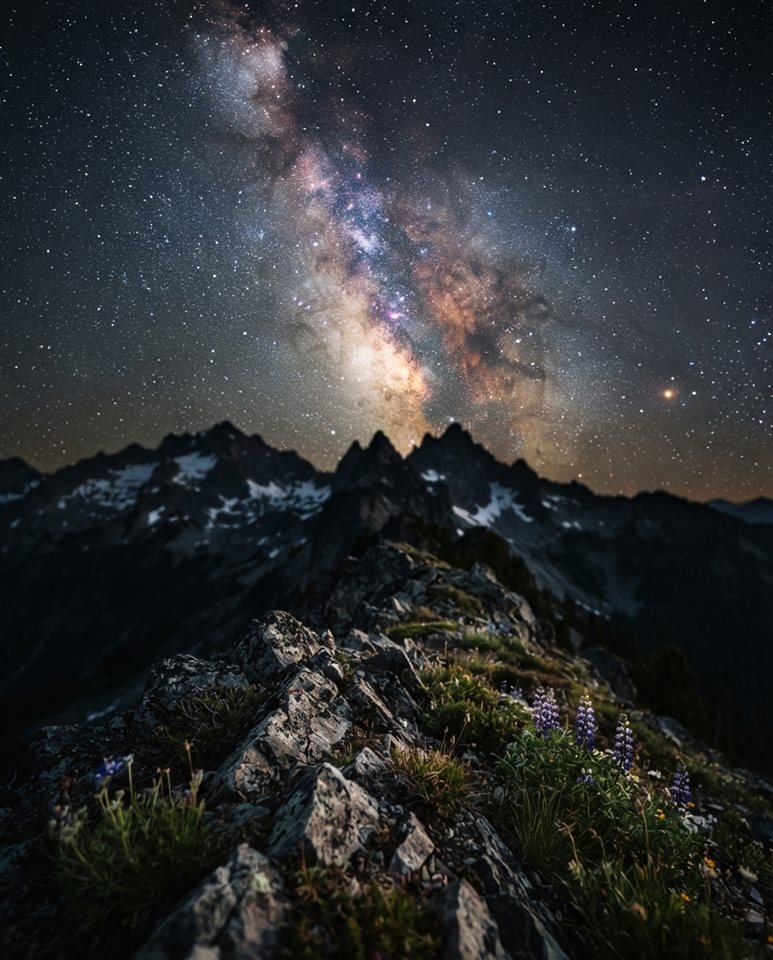 Cinematic film still of milky way over mountains, close-up detail with shallow depth of field, vivid colors, high contrast, energetic, 4:5 aspect ratio