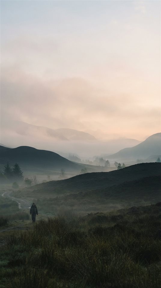 Cinematic film still of calm minimal landscape with plenty of empty space for text, wide shot with open space at the top for text, misty morning haze, dreamy, 9:16 aspect ratio