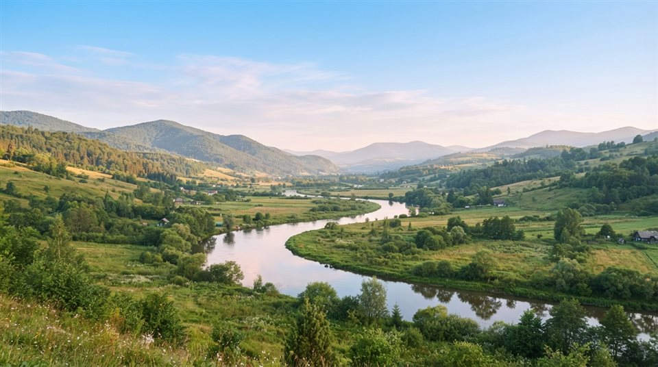 Photorealistic photo of winding river through a valley, wide shot with open space at the top for text, soft pastel colors, bright and cozy, 16:9 aspect ratio