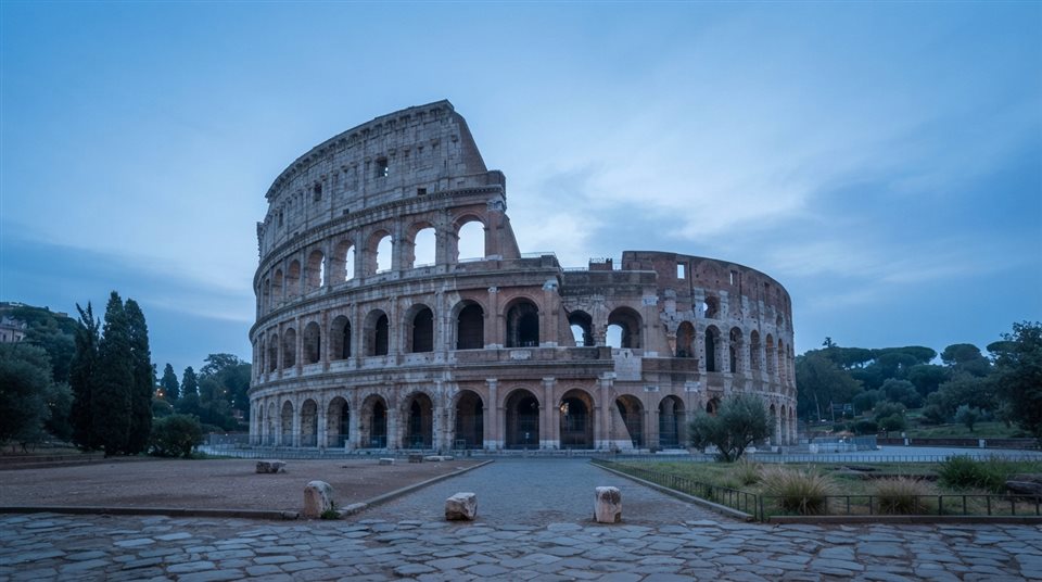 Photorealistic photo of the Colosseum in Rome, centered subject with a simple uncluttered composition, cool blue tones, quiet atmosphere, 16:9 aspect ratio