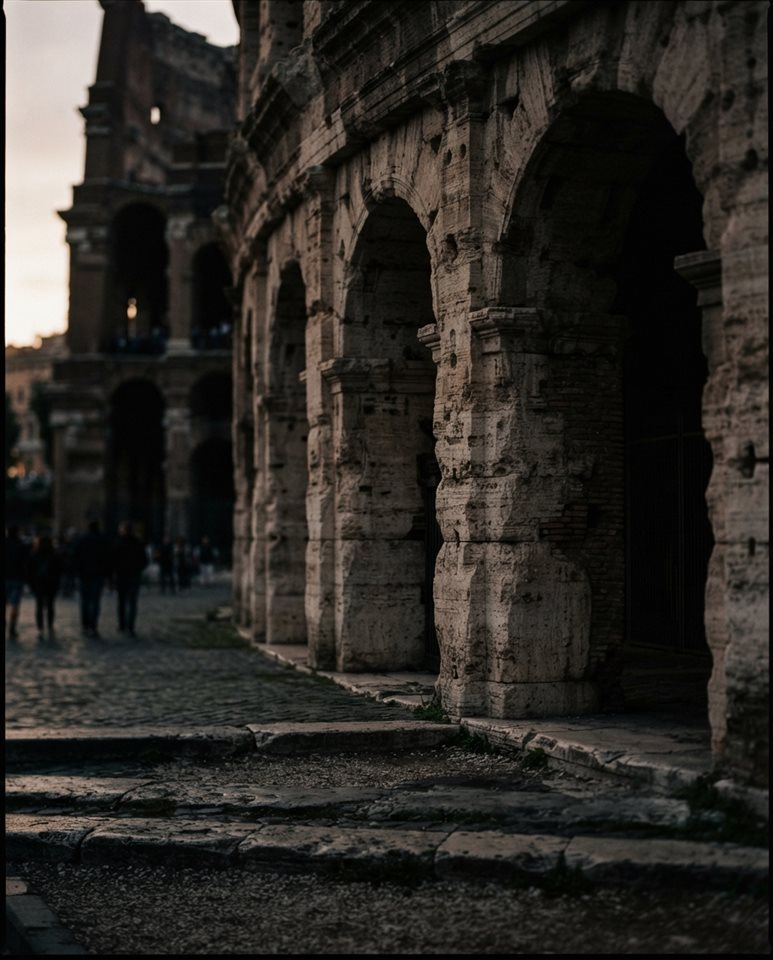 Cinematic film still of the Colosseum in Rome, close-up detail with shallow depth of field, moody dark tones, dramatic lighting, 4:5 aspect ratio