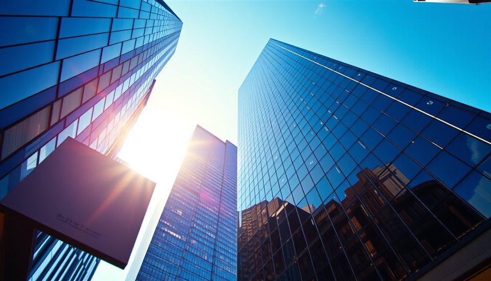 Cinematic film still of Looking straight up at modern glass skyscrapers piercing a bright blue sky., close-up detail with shallow depth of field, vivid colors, high contrast, energetic, 16:9 aspect ratio