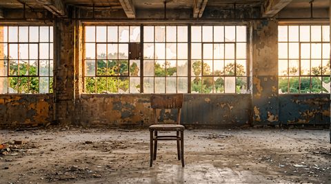 Photorealistic photo of abandoned building interior with broken windows, centered subject with a simple uncluttered composition, warm golden light, calm mood, 16:9 aspect ratio