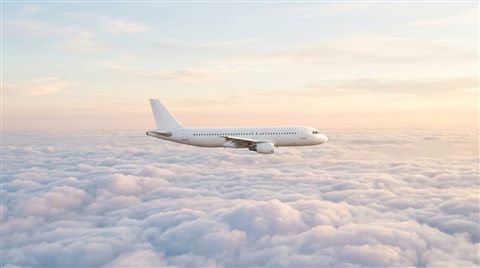 Photorealistic photo of an airplane flying above the clouds, centered subject with a simple uncluttered composition, soft pastel colors, bright and cozy, 16:9 aspect ratio