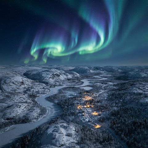 Photorealistic photo of aurora borealis over a snowy landscape, high-angle view from above, warm golden light, calm mood, 1:1 aspect ratio