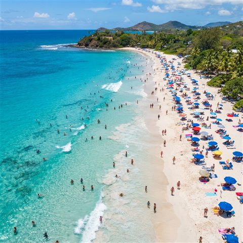 Photorealistic photo of sandy beach with clear turquoise water, high-angle view from above, vivid colors, high contrast, energetic, 1:1 aspect ratio