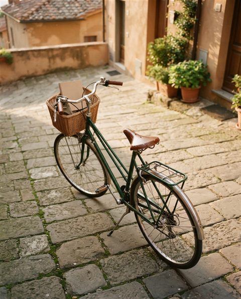 Cinematic film still of bicycle, high-angle view from above, warm golden light, calm mood, 4:5 aspect ratio