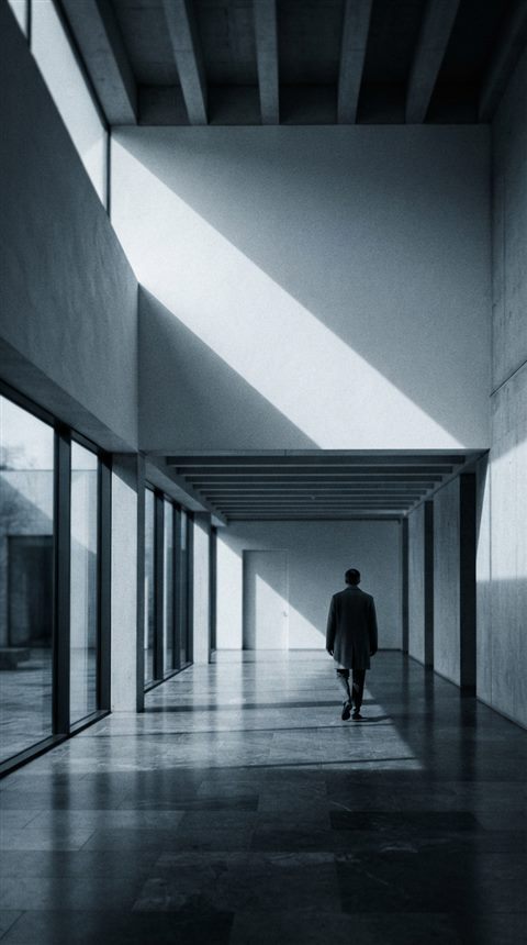 Cinematic film still of black and white minimalist scene with strong shadows, wide shot with open space at the top for text, cool blue tones, quiet atmosphere, 9:16 aspect ratio