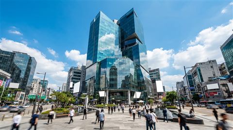 Photorealistic photo of modern glass building, wide shot with open space at the top for text, vivid colors, high contrast, energetic, 16:9 aspect ratio