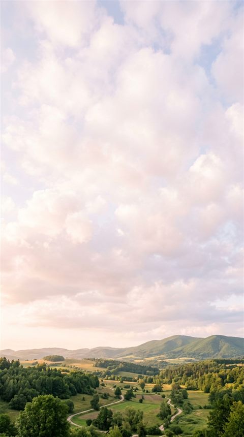 Cinematic film still of fluffy white clouds, wide shot with open space at the top for text, soft pastel colors, bright and cozy, 9:16 aspect ratio