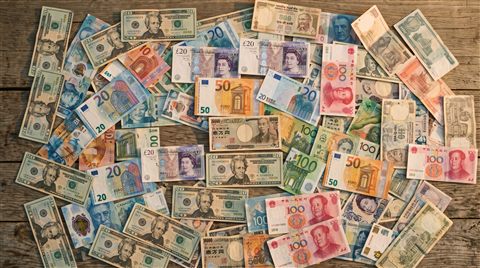 Cinematic film still of world currency banknotes, high-angle view from above, warm golden light, calm mood, 16:9 aspect ratio