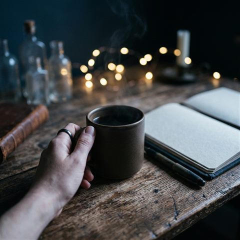 Photorealistic photo of dark moody aesthetic scene with soft glowing lights, close-up detail with shallow depth of field, cool blue tones, quiet atmosphere, 1:1 aspect ratio