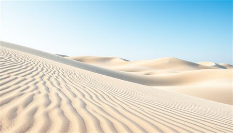Watercolor illustration of Vast sand dunes with sharp wind ripples under a clear blue sky, close-up detail with shallow depth of field, cool blue tones, quiet atmosphere, 16:9 aspect ratio