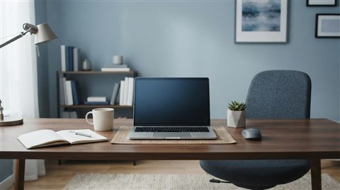 Photorealistic photo of workspace desk, wide shot with open space at the top for text, cool blue tones, quiet atmosphere, 16:9 aspect ratio