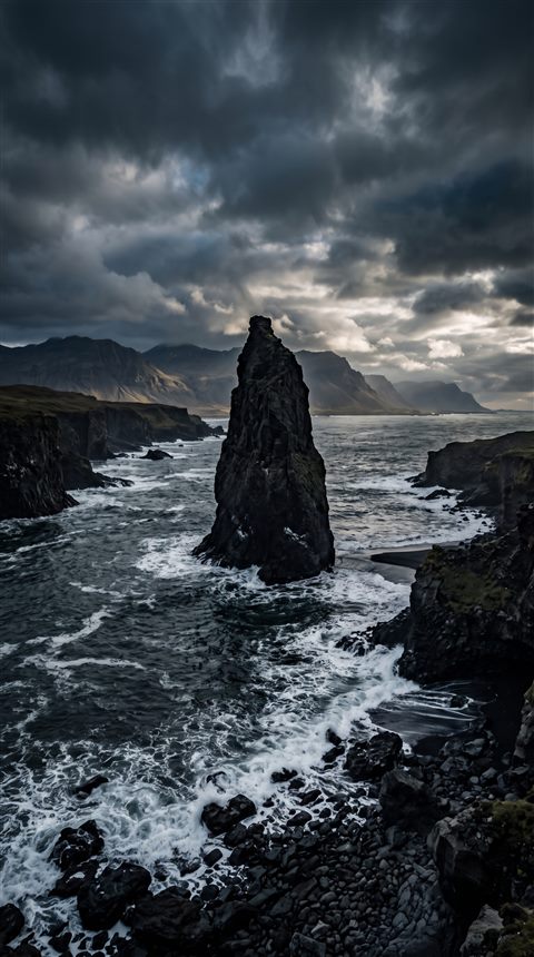 Photorealistic photo of breathtaking wide landscape for a computer desktop, centered subject with a simple uncluttered composition, moody dark tones, dramatic lighting, 9:16 aspect ratio
