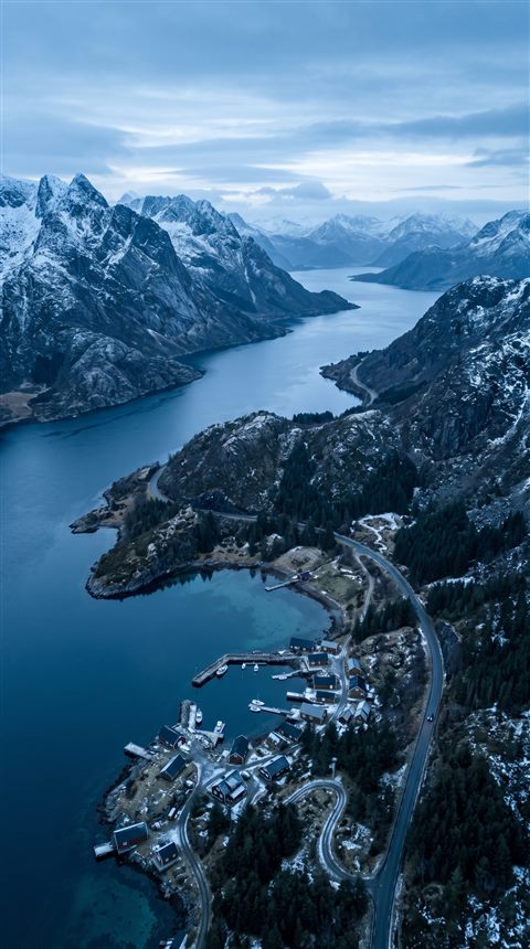Cinematic film still of breathtaking wide landscape for a computer desktop, high-angle view from above, cool blue tones, quiet atmosphere, 9:16 aspect ratio