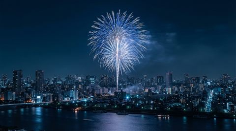 Photorealistic photo of fireworks over a city, centered subject with a simple uncluttered composition, cool blue tones, quiet atmosphere, 16:9 aspect ratio
