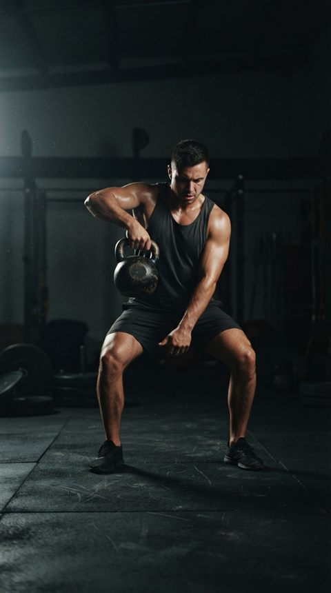 Cinematic film still of fitness workout, centered subject with a simple uncluttered composition, moody dark tones, dramatic lighting, 9:16 aspect ratio