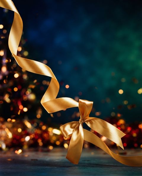 Cinematic film still of A shiny golden ribbon on a clean background, elegant and celebratory design element, wide shot with open space at the top for text, vivid colors, high contrast, energetic, 4:5 aspect ratio