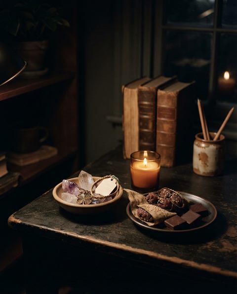 Photorealistic photo of lucky charms and traditional sweets for passing an exam, wide shot with open space at the top for text, moody dark tones, dramatic lighting, 4:5 aspect ratio