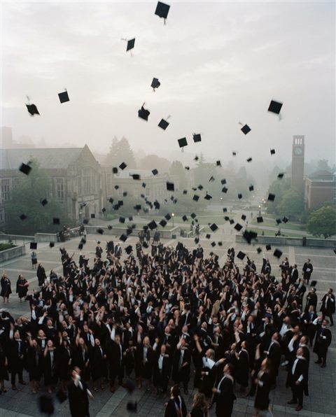 Cinematic film still of graduation caps tossed into the sky, high-angle view from above, misty morning haze, dreamy, 4:5 aspect ratio