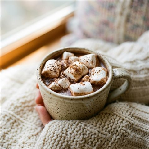 Photorealistic photo of mug of hot chocolate with marshmallows, close-up detail with shallow depth of field, soft pastel colors, bright and cozy, 1:1 aspect ratio