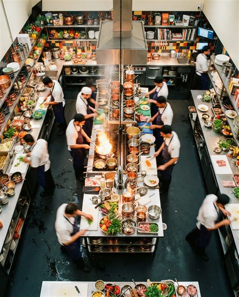 Cinematic film still of a clean bright kitchen, high-angle view from above, vivid colors, high contrast, energetic, 4:5 aspect ratio