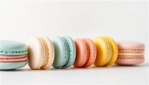 Minimal flat illustration of A neat row of colorful pastel macarons displayed on a minimalist white surface., close-up detail with shallow depth of field, soft pastel colors, bright and cozy, 16:9 aspect ratio