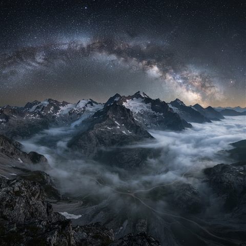 Photorealistic photo of milky way over mountains, high-angle view from above, misty morning haze, dreamy, 1:1 aspect ratio
