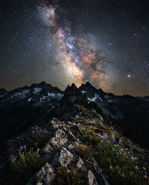 Cinematic film still of milky way over mountains, close-up detail with shallow depth of field, vivid colors, high contrast, energetic, 4:5 aspect ratio