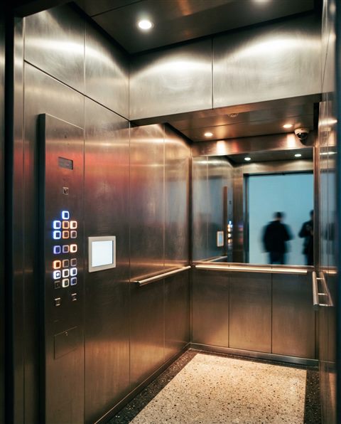 Cinematic film still of interior of a modern sleek stainless steel elevator with illuminated buttons, wide shot with open space at the top for text, vivid colors, high contrast, energetic, 4:5 aspect ratio
