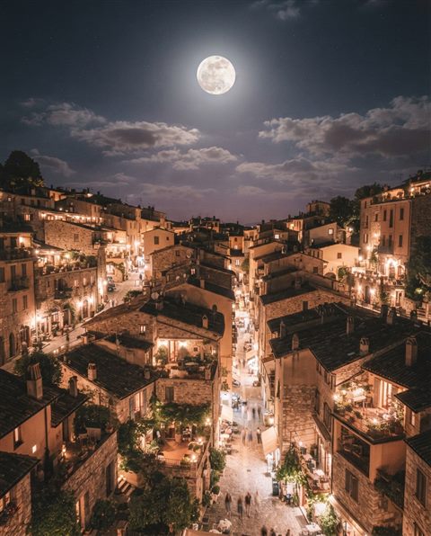 Cinematic film still of full moon in the night sky, high-angle view from above, soft pastel colors, bright and cozy, 4:5 aspect ratio