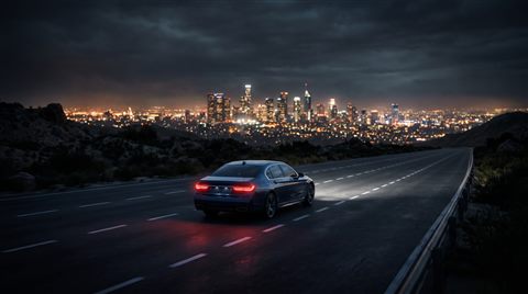Soft 3d render of car driving on an empty highway at night with city lights, centered subject with a simple uncluttered composition, moody dark tones, dramatic lighting, 16:9 aspect ratio