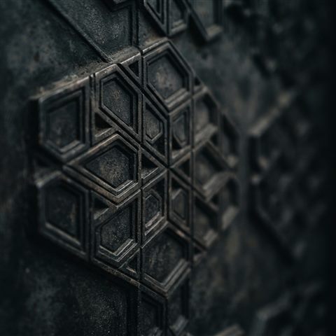 Photorealistic photo of seamless geometric pattern, close-up detail with shallow depth of field, moody dark tones, dramatic lighting, 1:1 aspect ratio