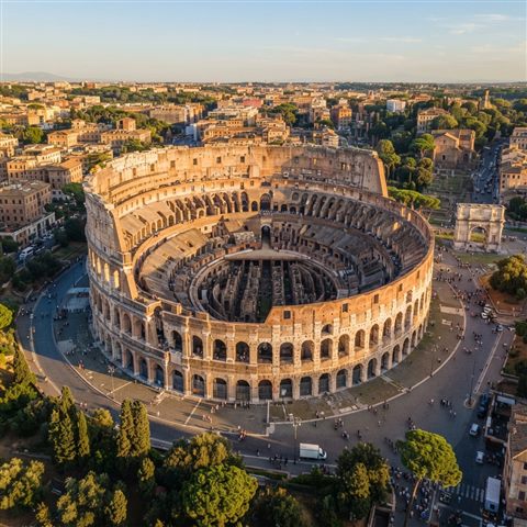 Photorealistic photo of the Colosseum in Rome, high-angle view from above, warm golden light, calm mood, 1:1 aspect ratio