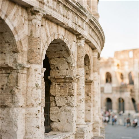 Photorealistic photo of the Colosseum in Rome, close-up detail with shallow depth of field, soft pastel colors, bright and cozy, 1:1 aspect ratio