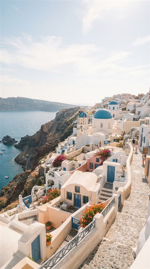 Cinematic film still of white houses of Santorini above the sea, wide shot with open space at the top for text, soft pastel colors, bright and cozy, 9:16 aspect ratio