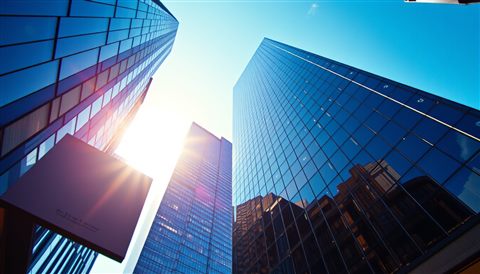 Cinematic film still of Looking straight up at modern glass skyscrapers piercing a bright blue sky., close-up detail with shallow depth of field, vivid colors, high contrast, energetic, 16:9 aspect ratio