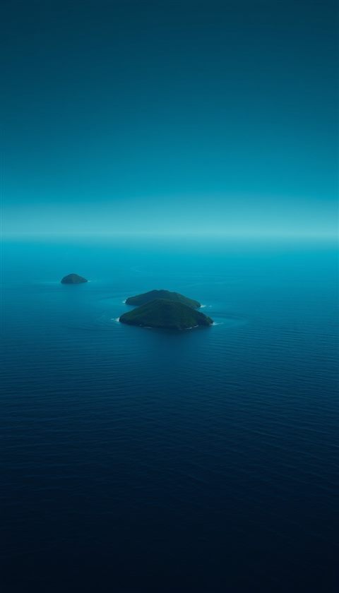Photorealistic photo of Calm, deep blue ocean waters dotted with small, hazy green islands under a serene, clear horizon., centered subject with a simple uncluttered composition, moody dark tones, dramatic lighting, 9:16 aspect ratio
