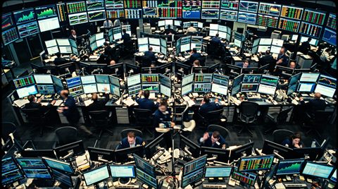 Cinematic film still of stock market trading screens, high-angle view from above, vivid colors, high contrast, energetic, 16:9 aspect ratio